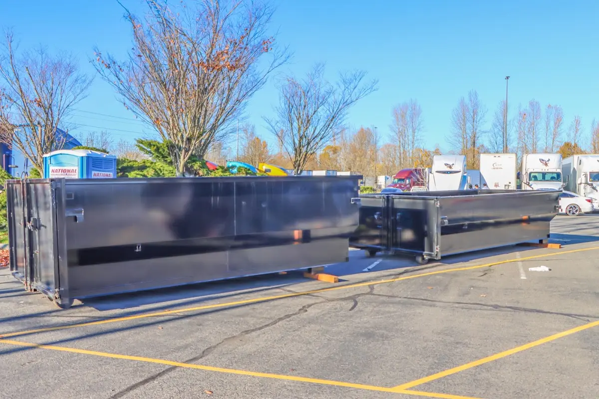 Professional dumpster rental service with roll-off container on residential driveway in Hainesport